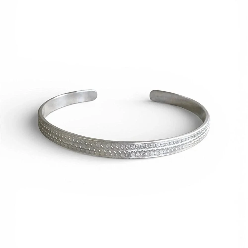 Brushed sterling silver scalloped open cuff bangle bracelet with satin finish.